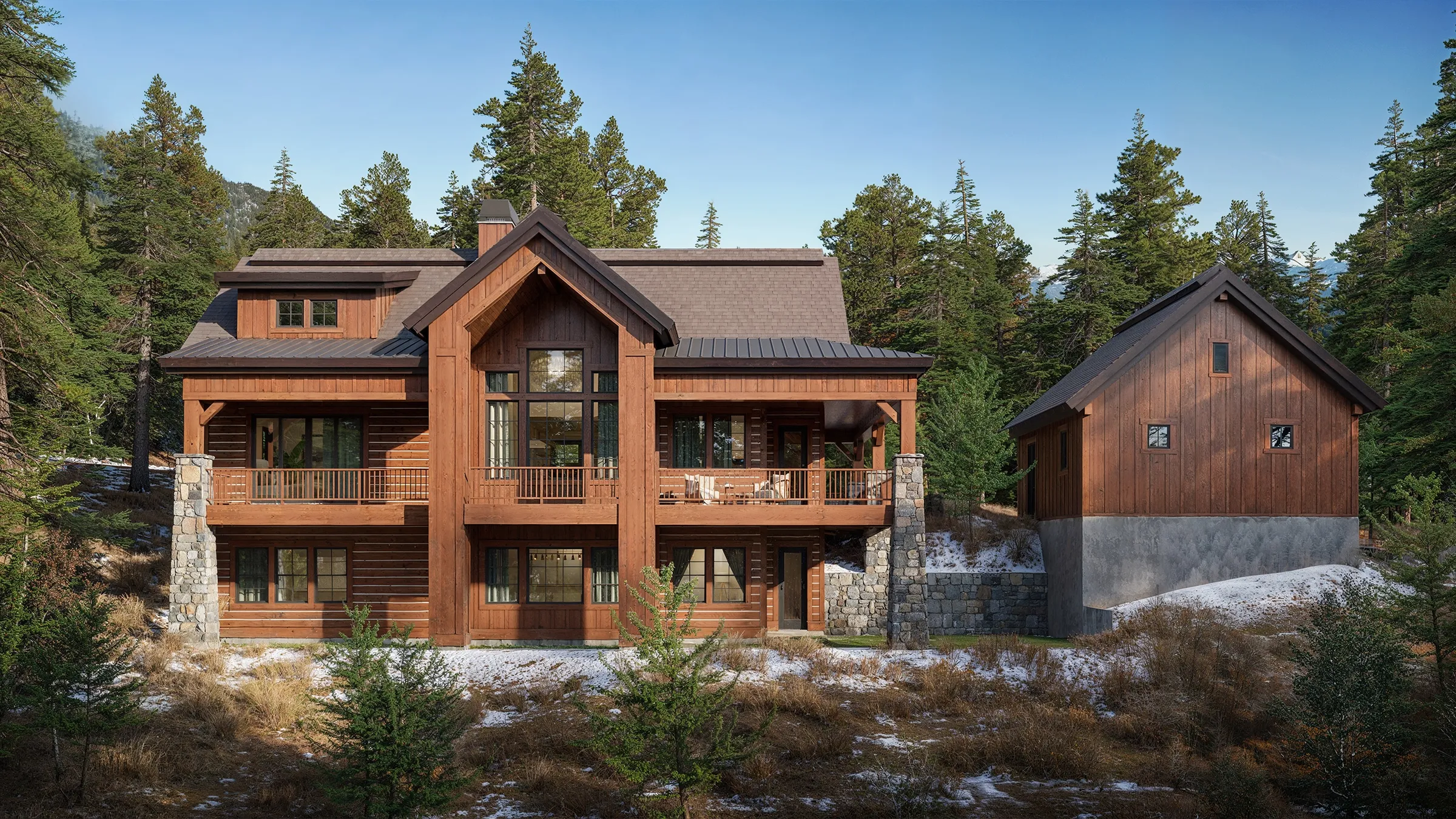 Photorealistic 3D rendering of the rear exterior of the Haystack, a mountain-style timber and stone home by Alturas Homes at Tamarack Resort, Idaho, with stacked covered balconies among the pines.
