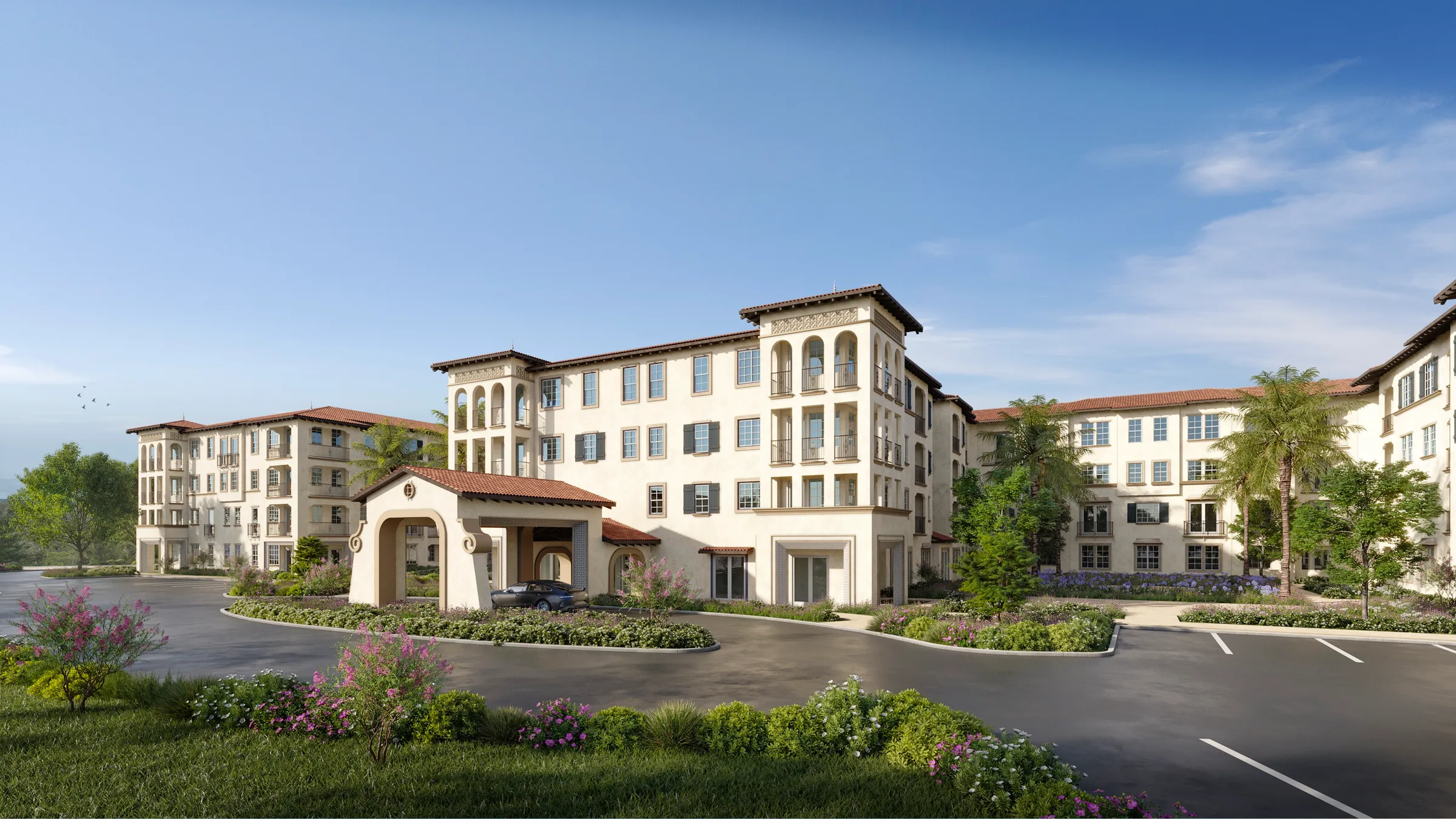 Daytime 3D rendering of Anindell in Folsom, California, a four-story Mediterranean-style building in cream stucco with a terracotta tile roof and an arched porte-cochere, set among landscaped grounds.
