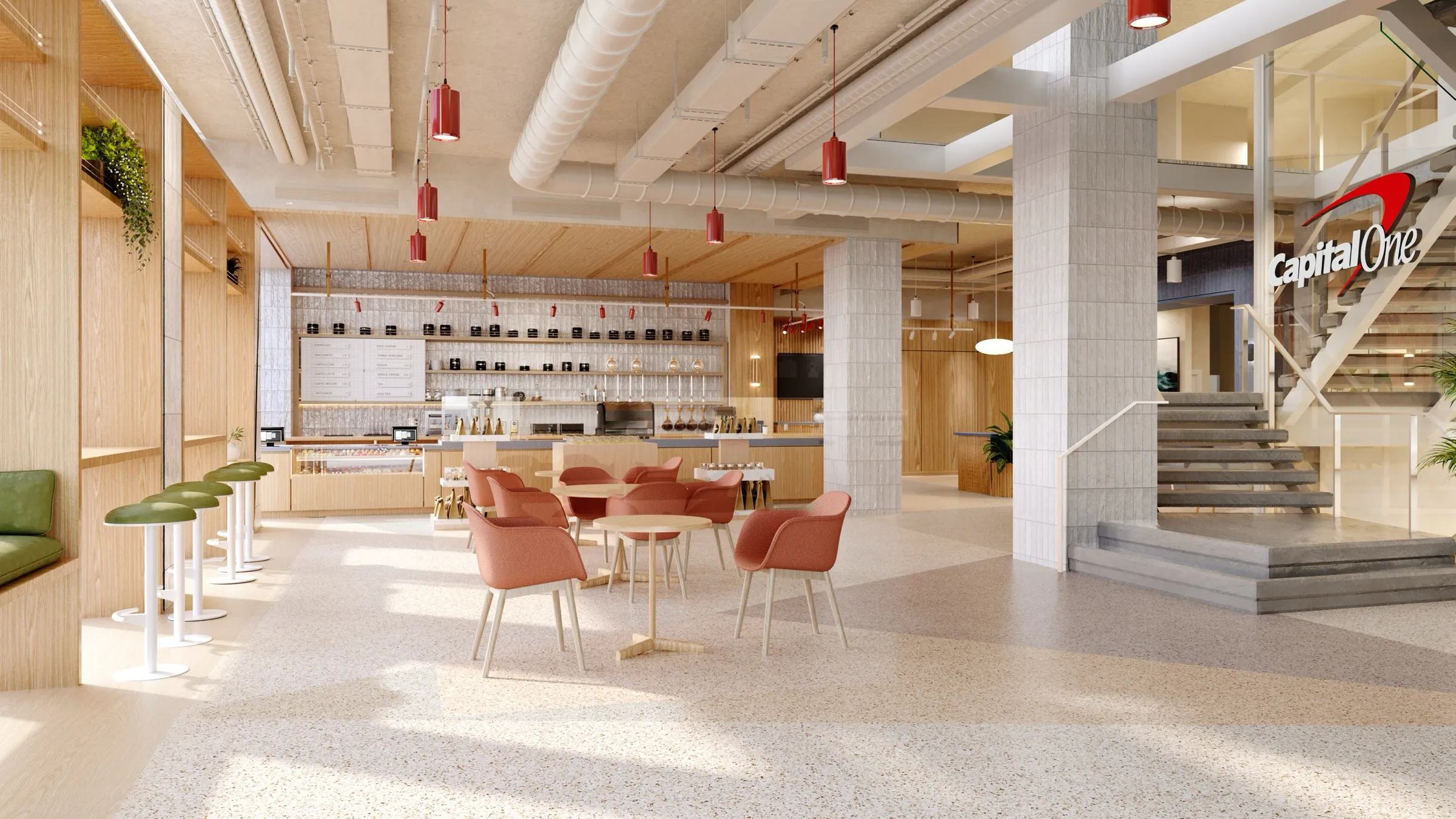 3D interior rendering of the Capital One Café at Union Square in Manhattan, with a coffee bar lit by red pendant lights, coral tub chairs, a terrazzo floor, and the Capital One logo beside a staircase.