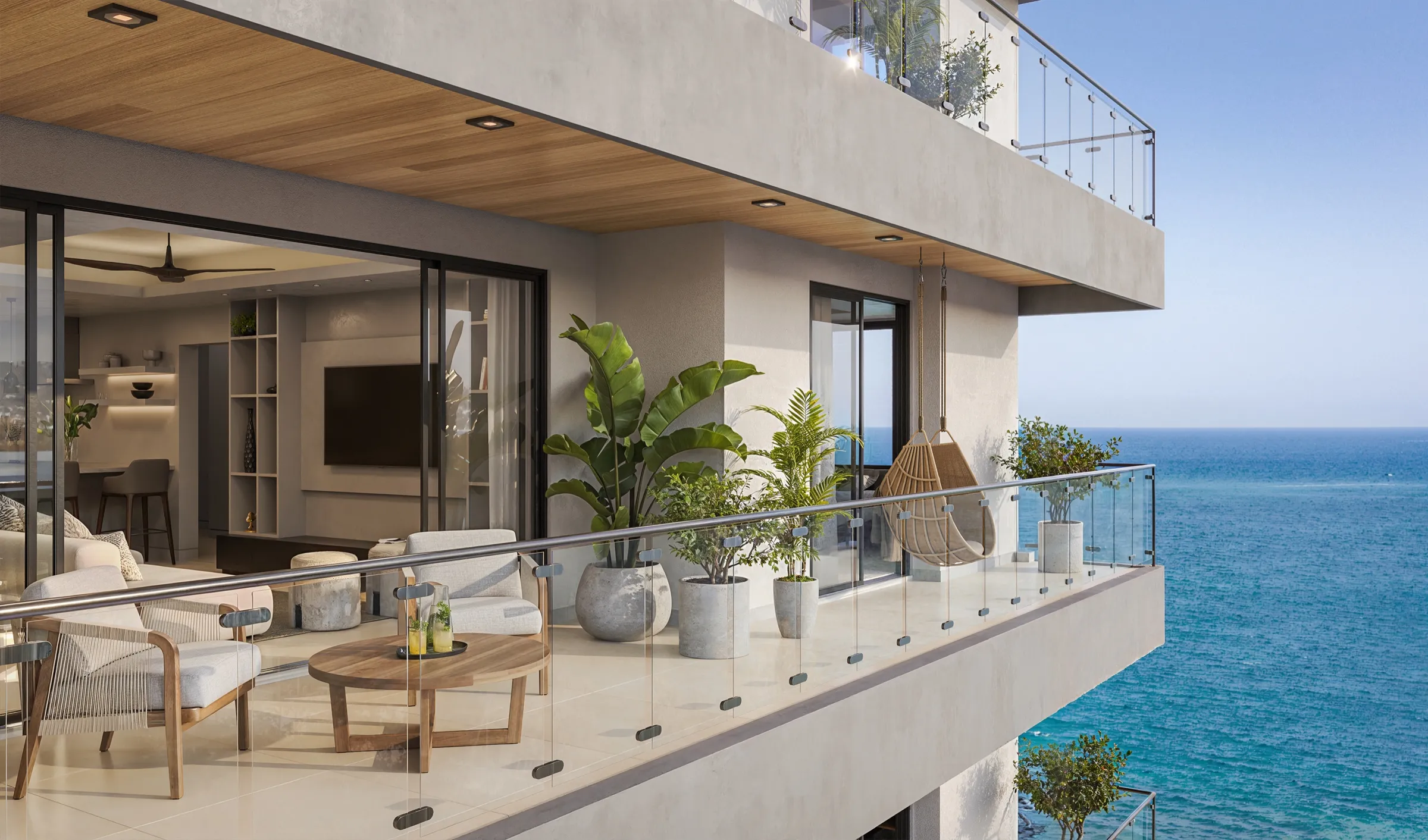 The Elysian balcony rendering with lounge seating and planting, looking along the facade and out to the sea