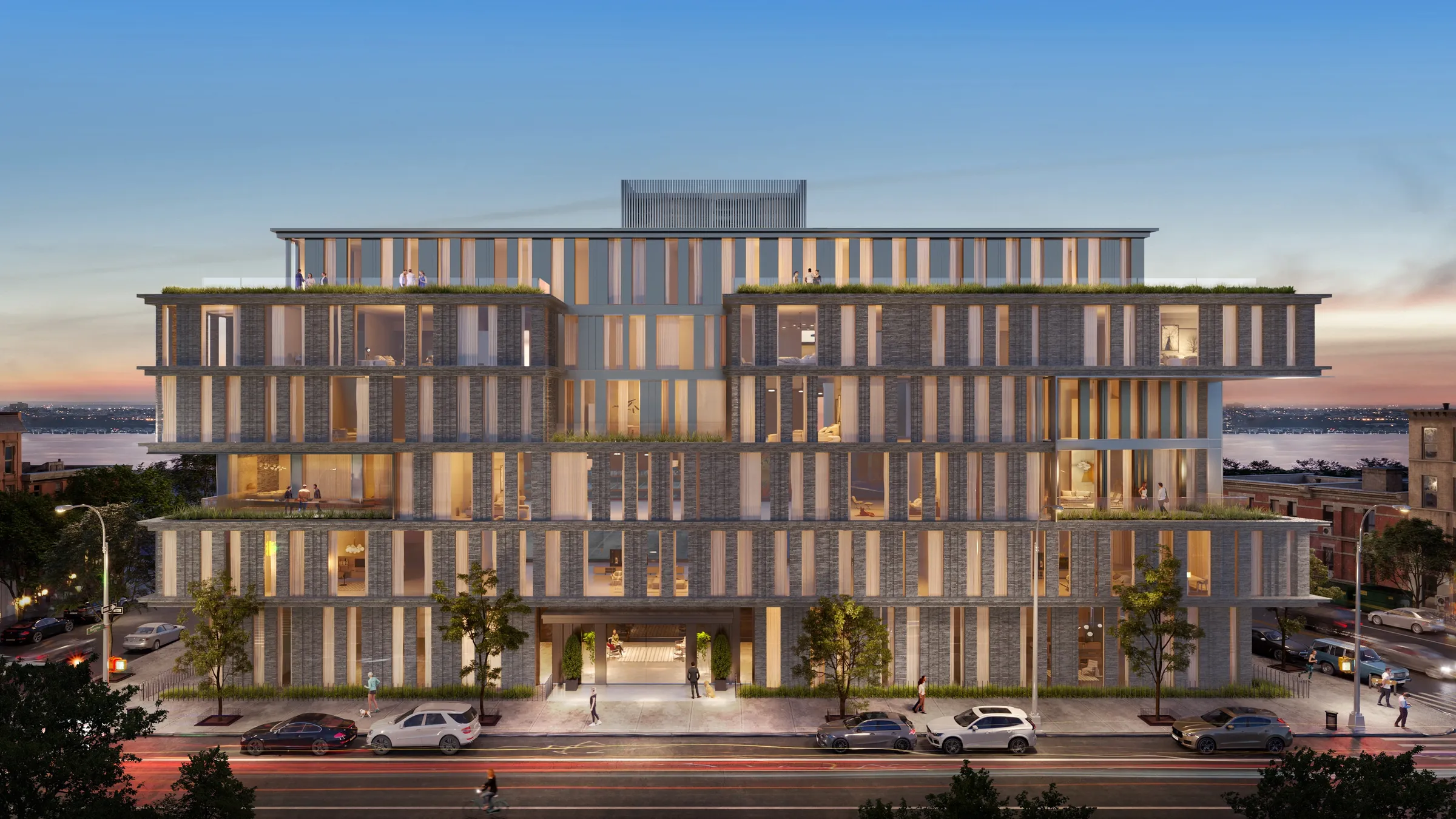Sunset 3D rendering of the West Village concept's full street elevation, a brick facade carved into stepped, planted terraces with warmly lit apartments, the Hudson River visible at the ends of the block.