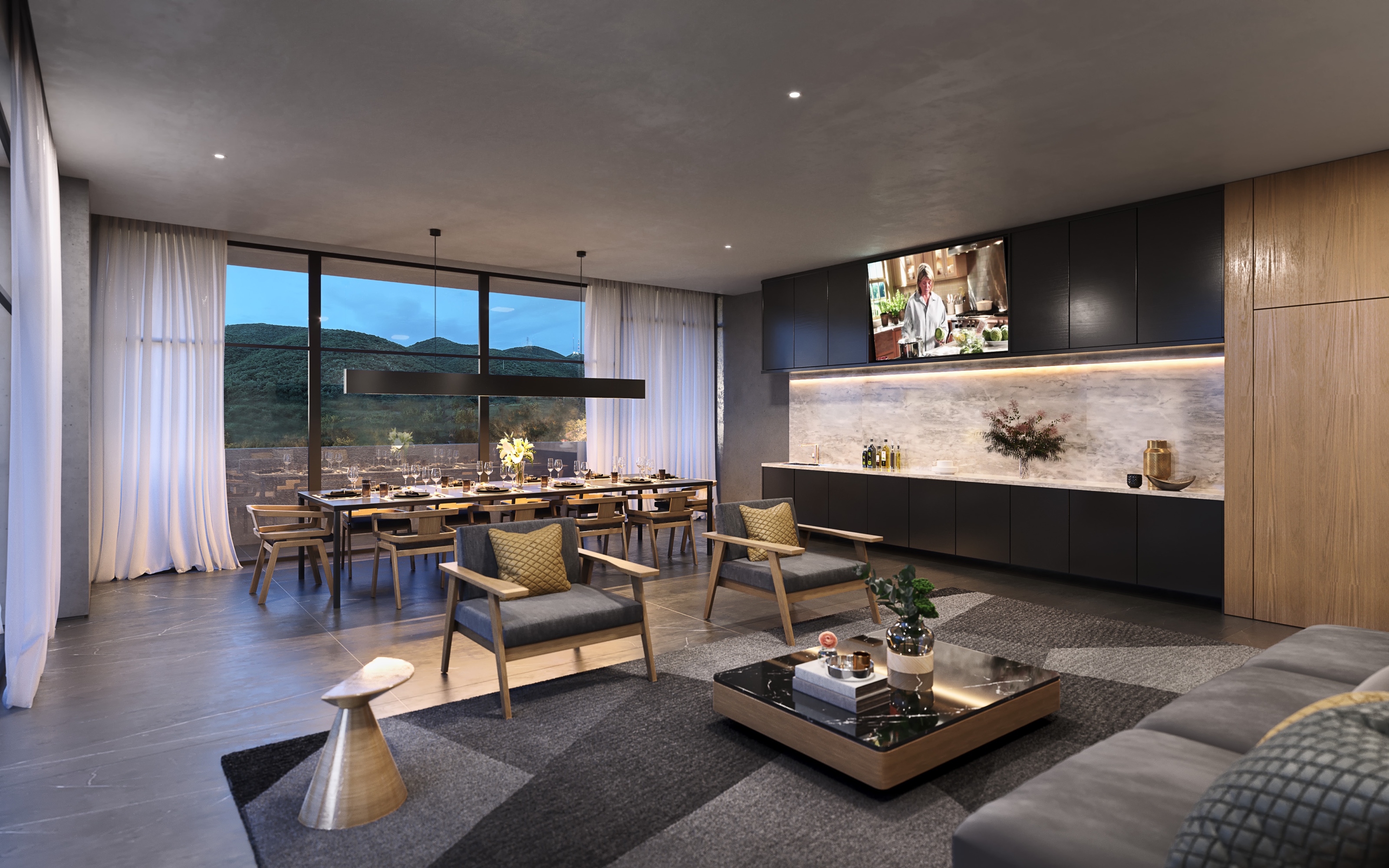 Dusk 3D rendering of the communal kitchen at Torres Acacia, a long set dining table by full-height glazing with mountain views, dark cabinetry with a backlit stone splashback, and a lounge corner in front.